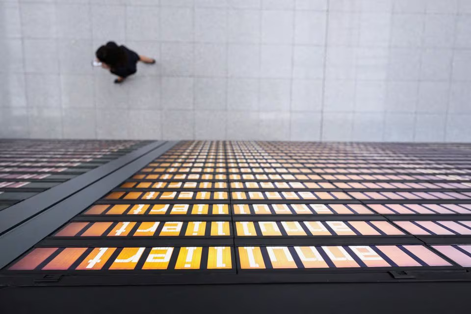 A person walks past a departures board inside the Munich Airport in Munich, Germany, March 26, 2023. Photo: Reuters