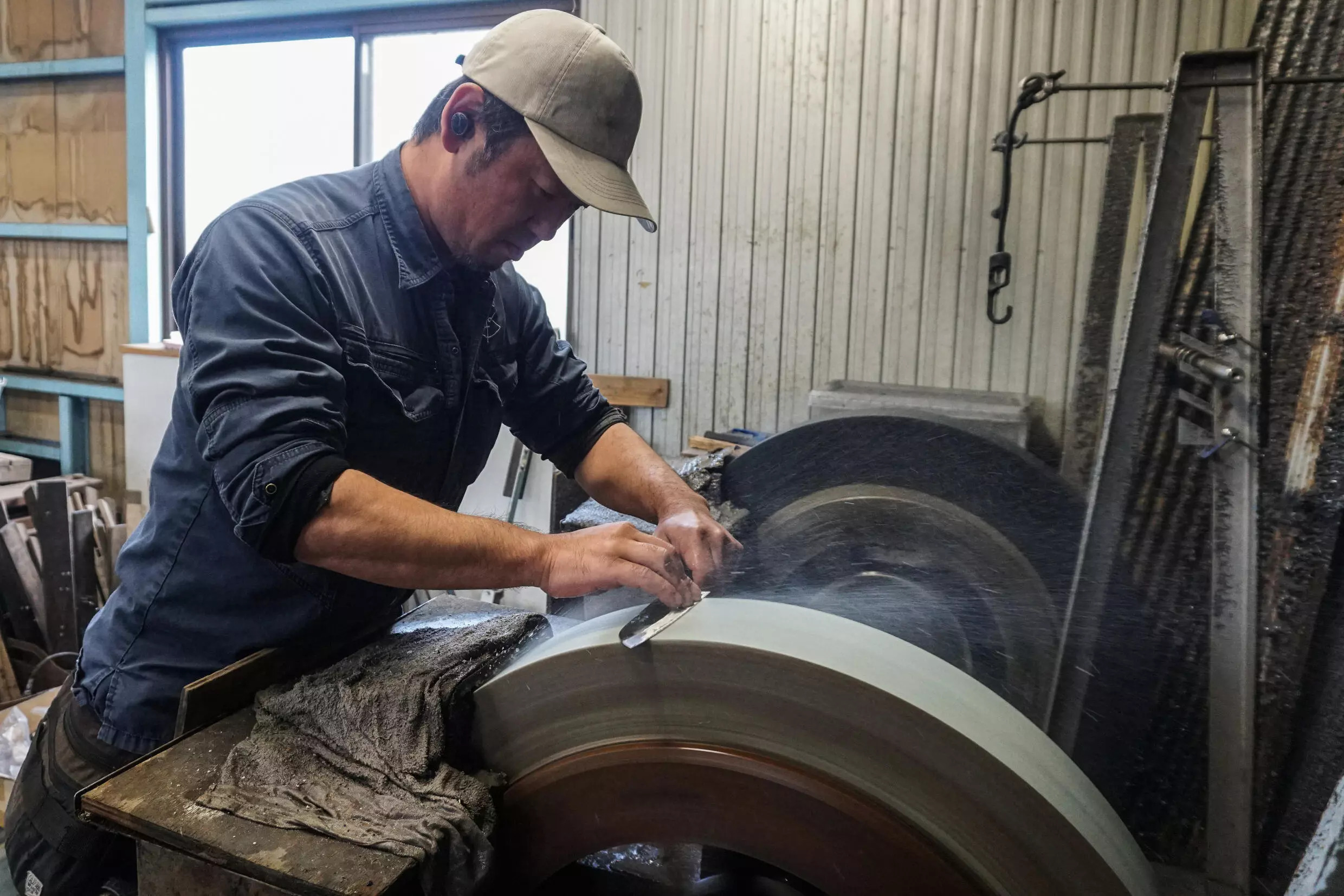 Yoshihiro Yauji sharpens a freshly forged 'santoku', a multipurpose knife, at the Takefu Knife Village in Fukui prefecture. Photo: AFP