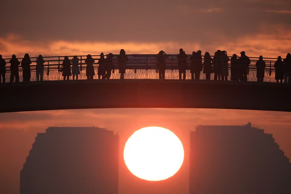 People on a bridge look at the first sunrise of the year at a park in Seoul, South Korea, January 1, 2024. Photo: Reuters