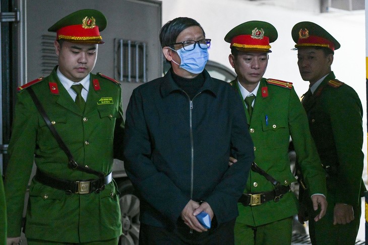 Former Minister of Health Nguyen Thanh Long is taken to the court in Hanoi. Photo: Nam Tran / Tuoi Tre