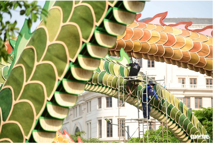 Workers install scales on the 100-meter-long dragon sculptures.
