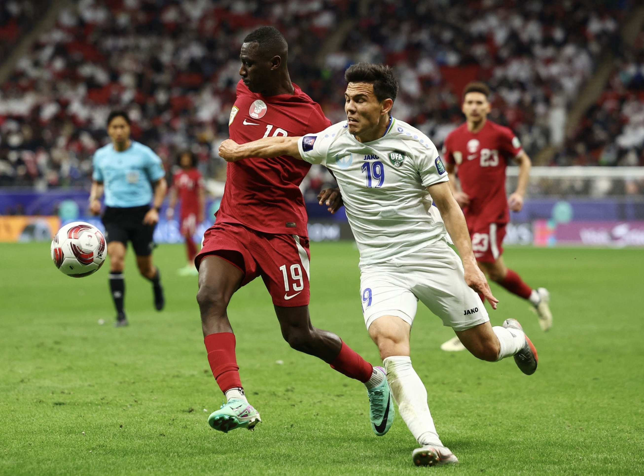 Soccer Football - AFC Asian Cup - Quarter Final - Qatar v Uzbekistan - Al Bayt Stadium, Al Khor, Qatar - February 3, 2024 Uzbekistan's Azizbek Turg'unboyev in action with Qatar's Almoez Ali. Photo: Reuters