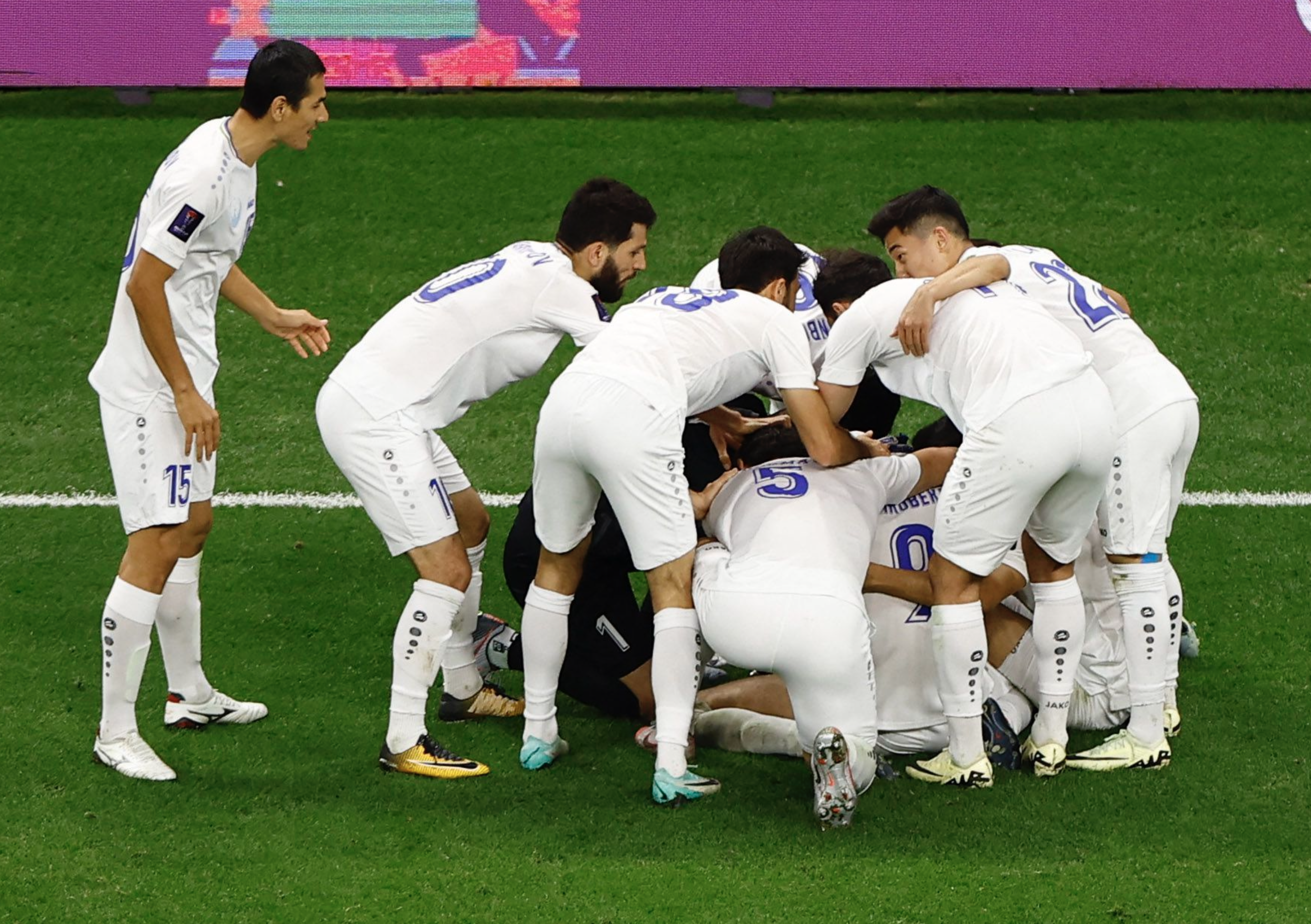 Soccer Football - AFC Asian Cup - Quarter Final - Qatar v Uzbekistan - Al Bayt Stadium, Al Khor, Qatar - February 3, 2024 Uzbekistan's Odildzhon Khamrobekov celebrates scoring their first goal with teammates. Photo: Reuters