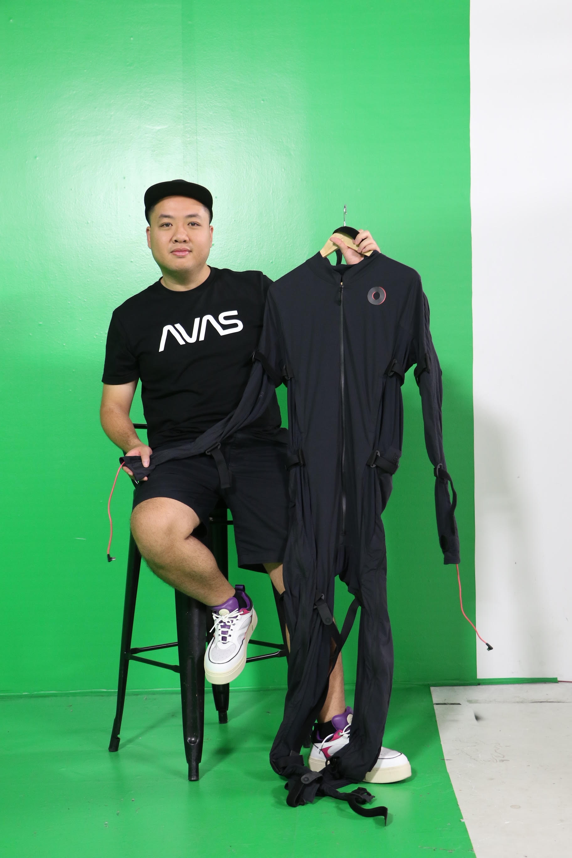 Tung Monkey poses for a photo with a motion capture outfit, which is used to create virtual characters. Photo: B.M. / Tuoi Tre
