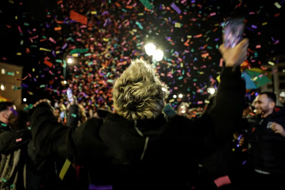 Members of the LGBTQ+ community and supporters celebrate in front of the Greek parliament, after the vote in favour of a bill which approved allowing same-sex civil marriages, in Athens, Greece, February 15, 2024. Photo: Reuters