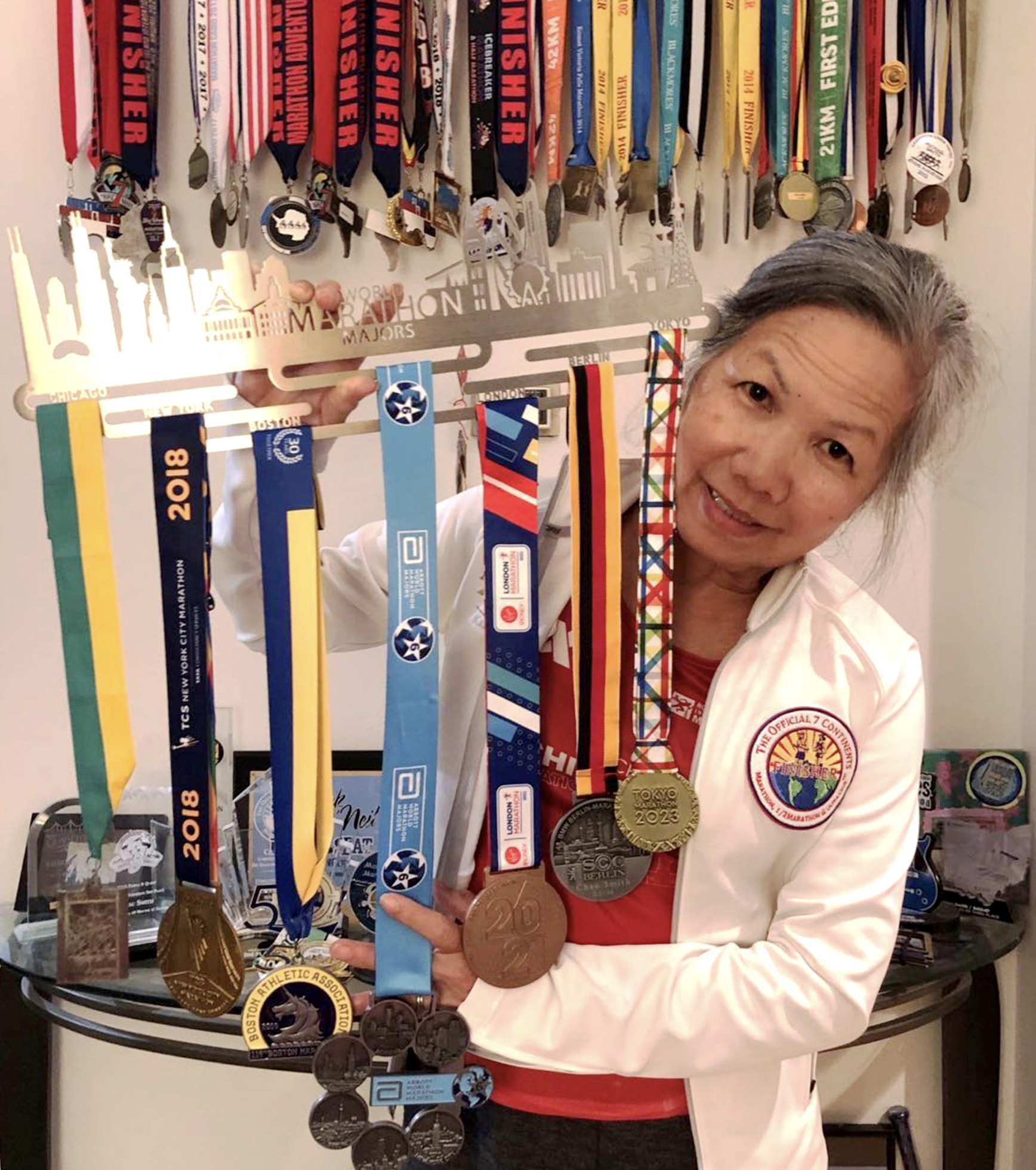 Chau Smith shows her collection of medals at marathon events on seven continents. Photo: Supplied
