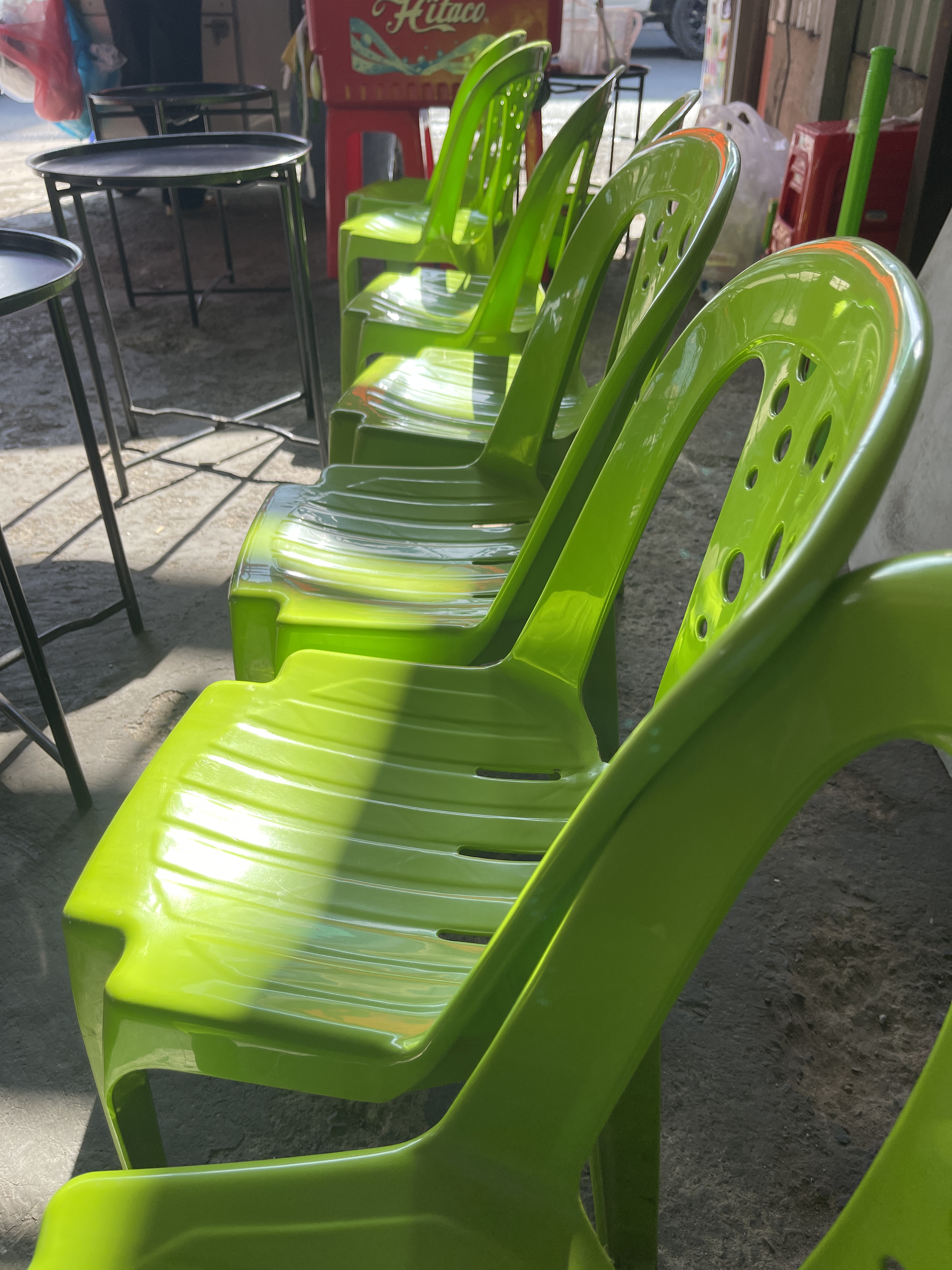 Green monobloc chairs are used at a coffee shop on the street in Ho Chi Minh City. Photo: Dong Nguyen / Tuoi Tre
