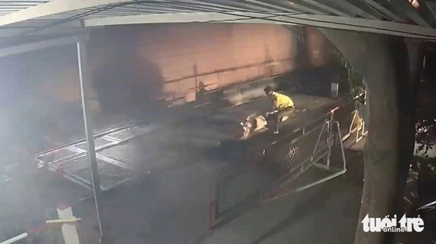 A screenshot from camera footage shows Dung saving the man from being hit by the speeding train.