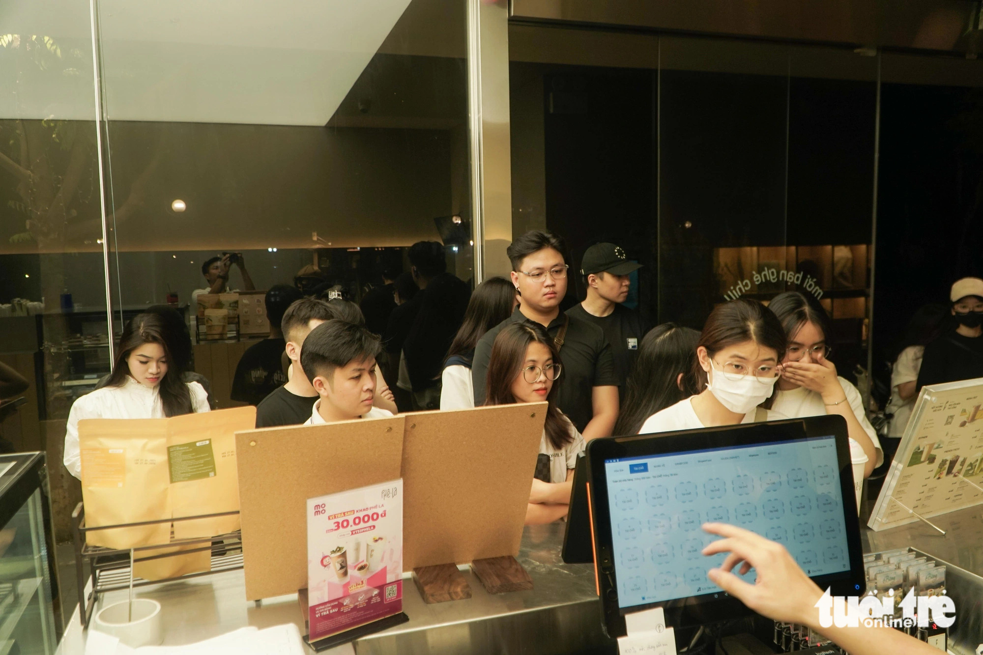 Customers line up at the order counter at a coffee shop on Tong Dan Street in Hoan Kiem District, Hanoi, at dawn on June 14, 2024. Photo: Pham Tuan / Tuoi Tre