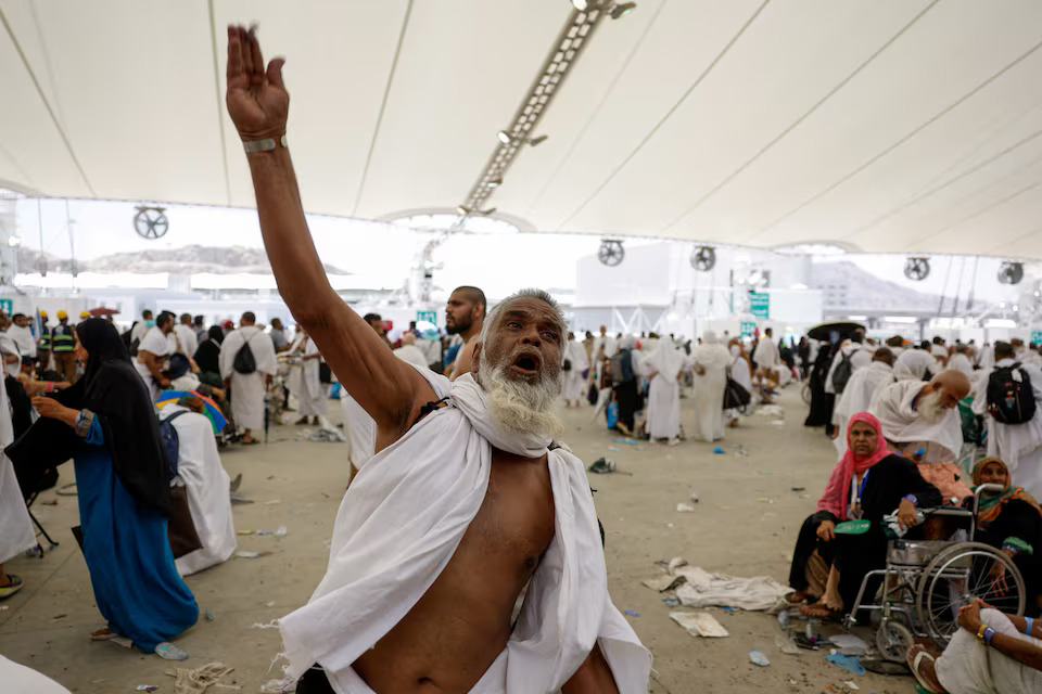 [12/42]A man gestures as Muslim pilgrims cast their stones at a pillar symbolising Satan, during the annual haj pilgrimage in Mina, Saudi Arabia, June 16. REUTERS/Mohammed Torokman Purchase Licensing Rights