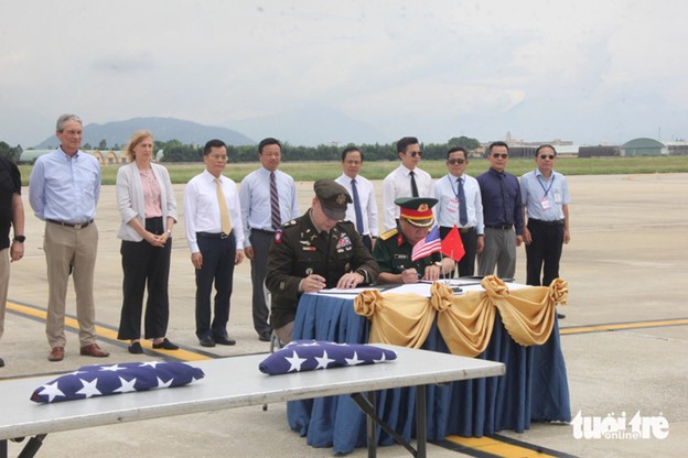 Representatives of the Vietnamese Ministry of National Defense and the U.S. Department of Defense sign an agreement on the handover of the remains. Photo: Truong Trung / Tuoi Tre