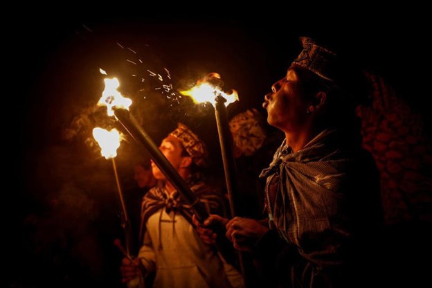 Tenggerese Hindu worshippers blow their torches before walking up Mount Bromo during the Yadnya Kasada festival in Probolinggo, East Java, Indonesia, June 22, 2024.
