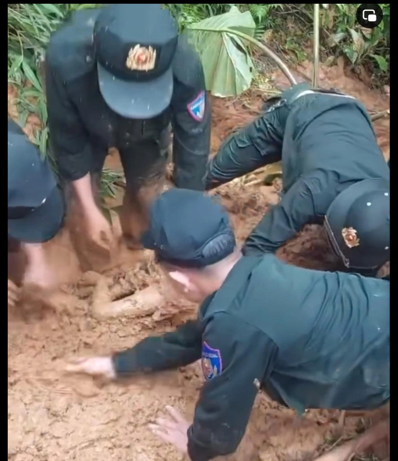 A screenshot of a video clip showing rescuers manually recovering the body of a landslide-hit baby boy. Photo: Supplied