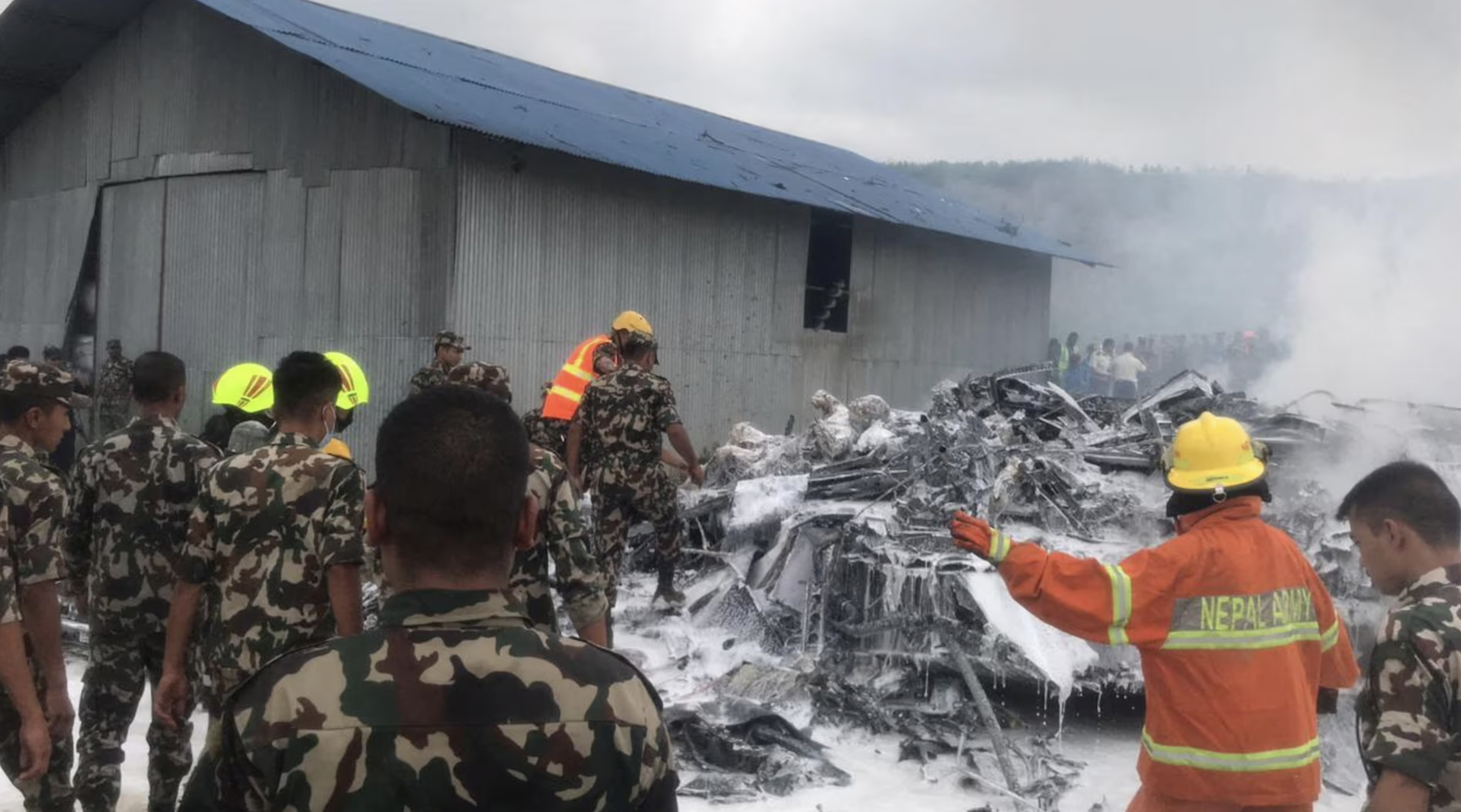 Emergency services work at the accident site of a Saurya Airlines plane that caught fire after skidding off the runway while taking off, in Kathmandu, Nepal July 24, 2024. Photo: Reuters