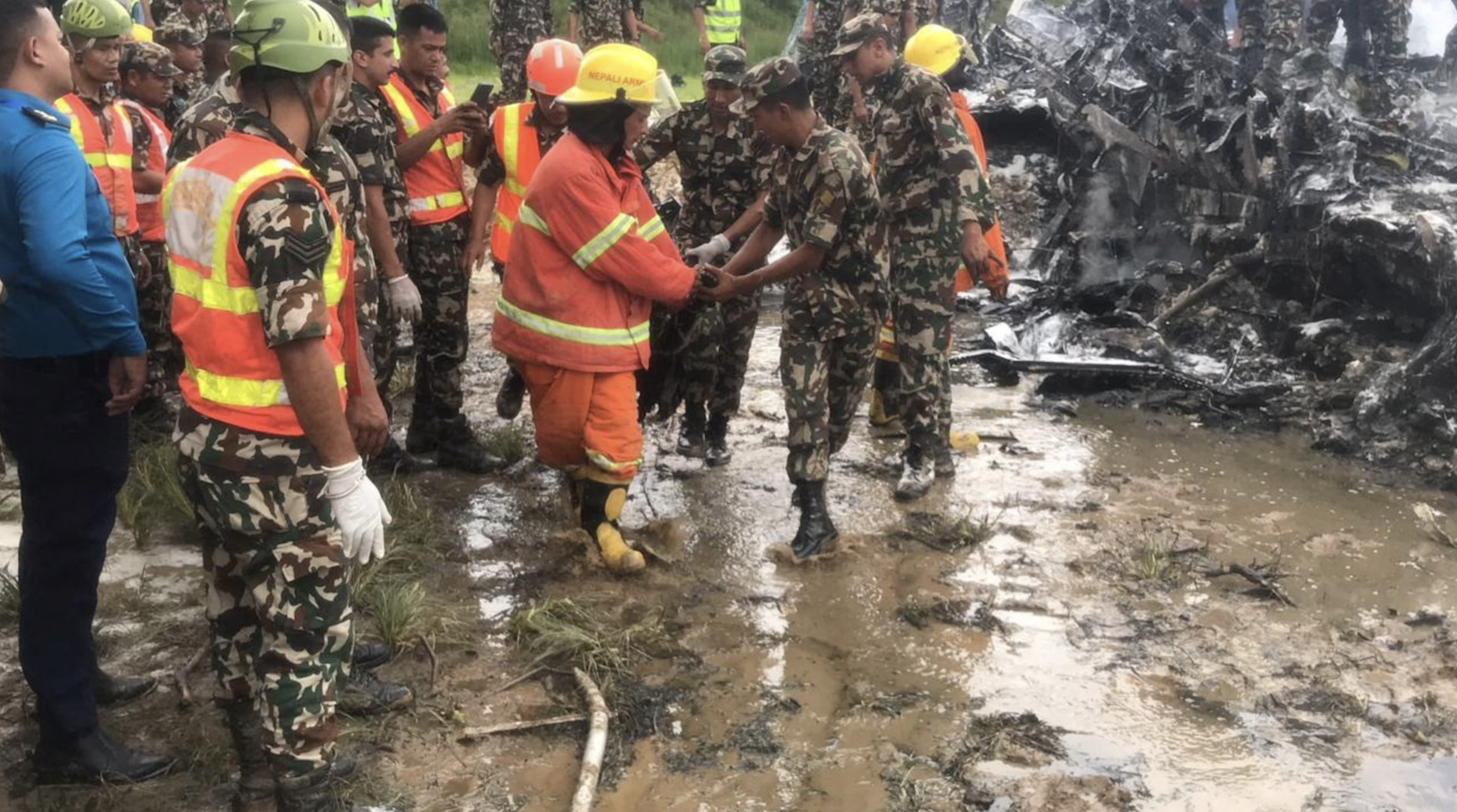 Emergency services work at the accident site of a Saurya Airlines plane that caught fire after skidding off the runway while taking off, in Kathmandu, Nepal July 24, 2024. Photo: Reuters