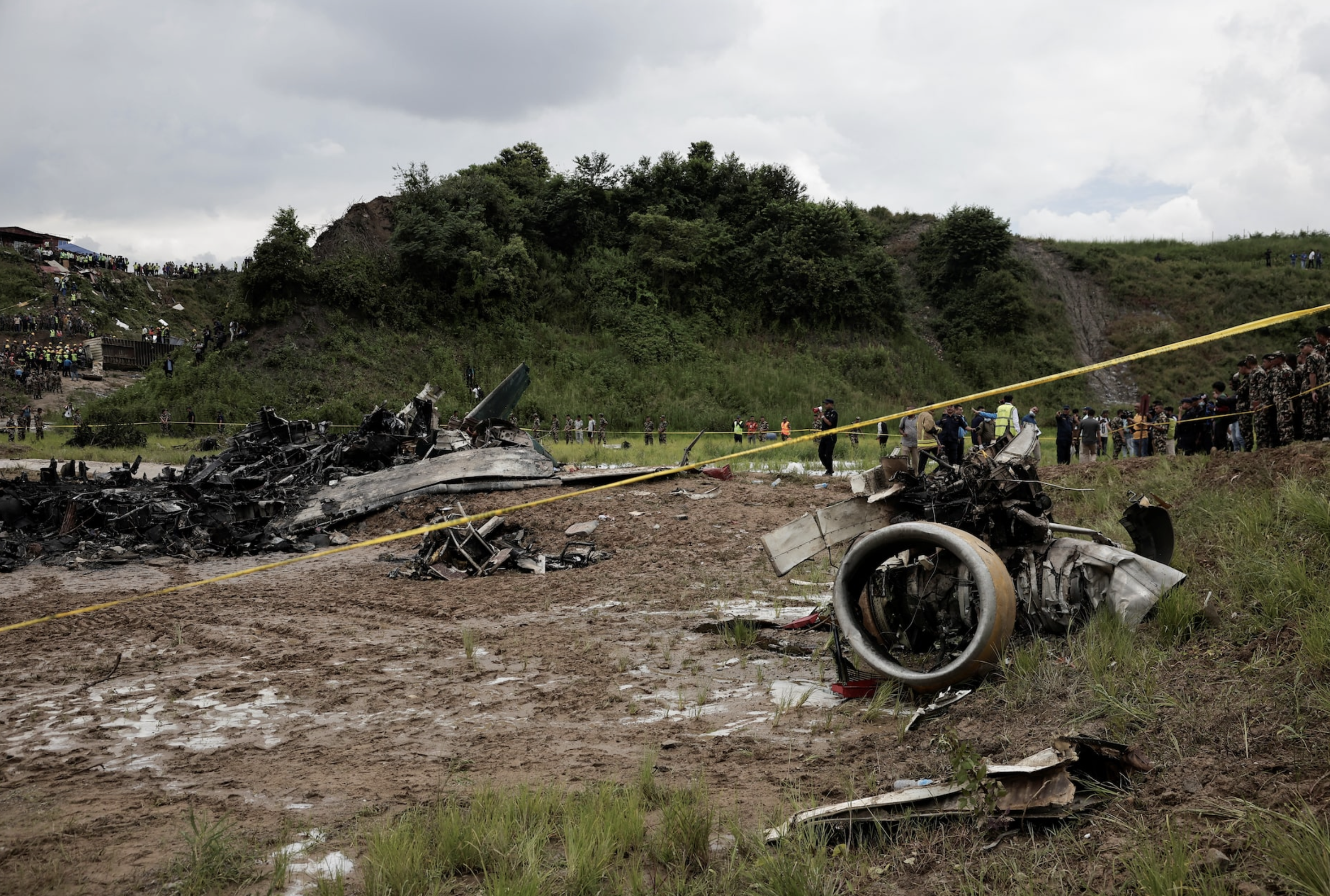 Emergency personnel work at the accident site of a Saurya Airlines plane that caught fire after skidding off the runway while taking off at Tribhuvan International Airport, in Kathmandu, Nepal July 24, 2024. Photo: Reuters