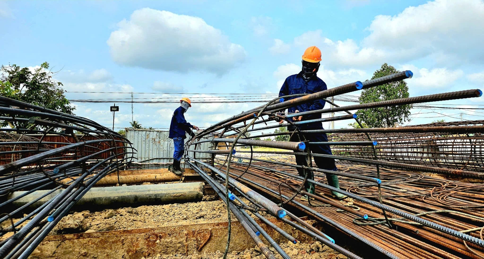 Workers at the construction site of Provincial Road 823D in Long An Province.