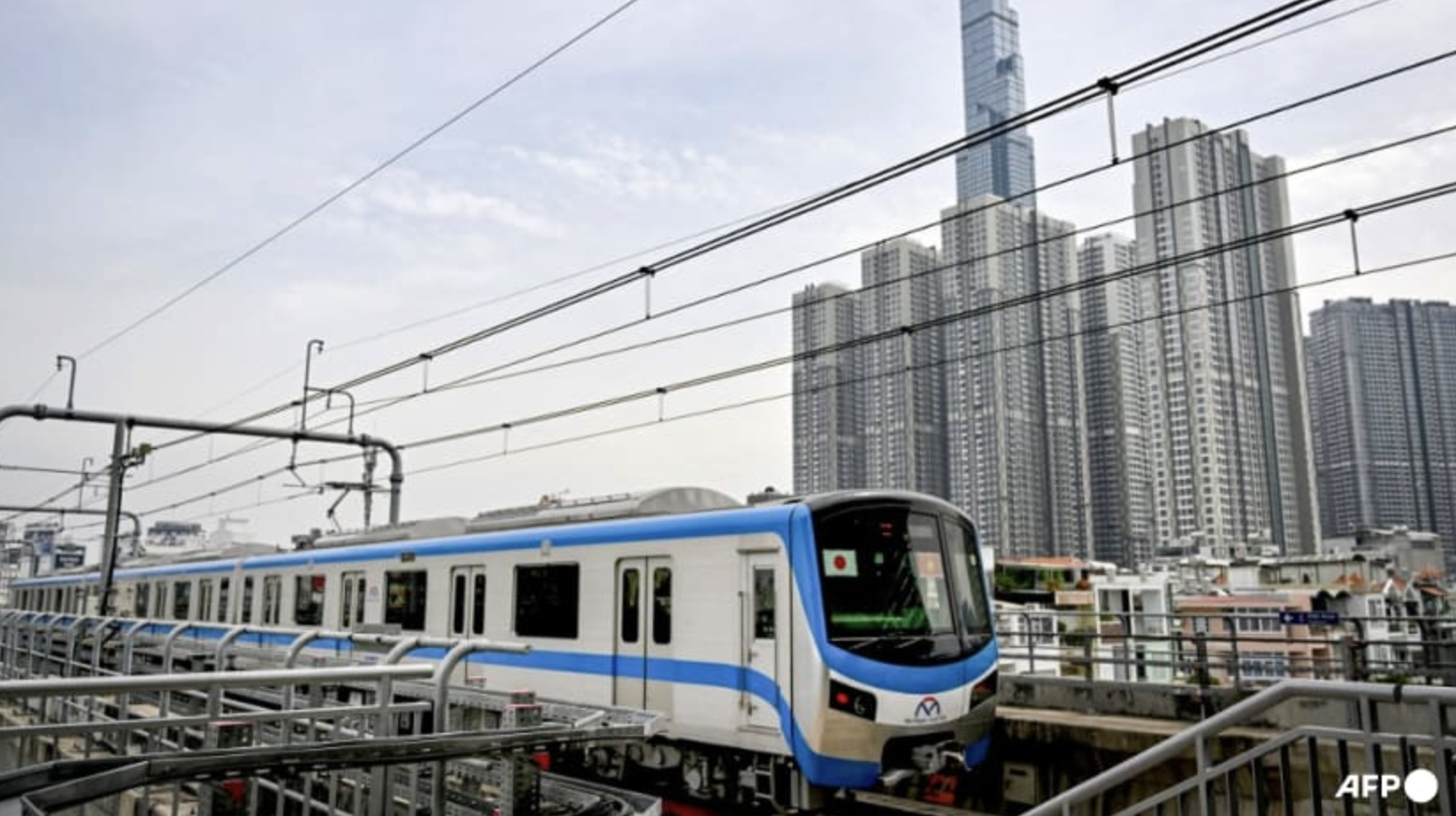 A train of Ho Chi Minh City's Metro Line No.1 is seen past residential buildings on Dec 22, 2024. Photo: AFP