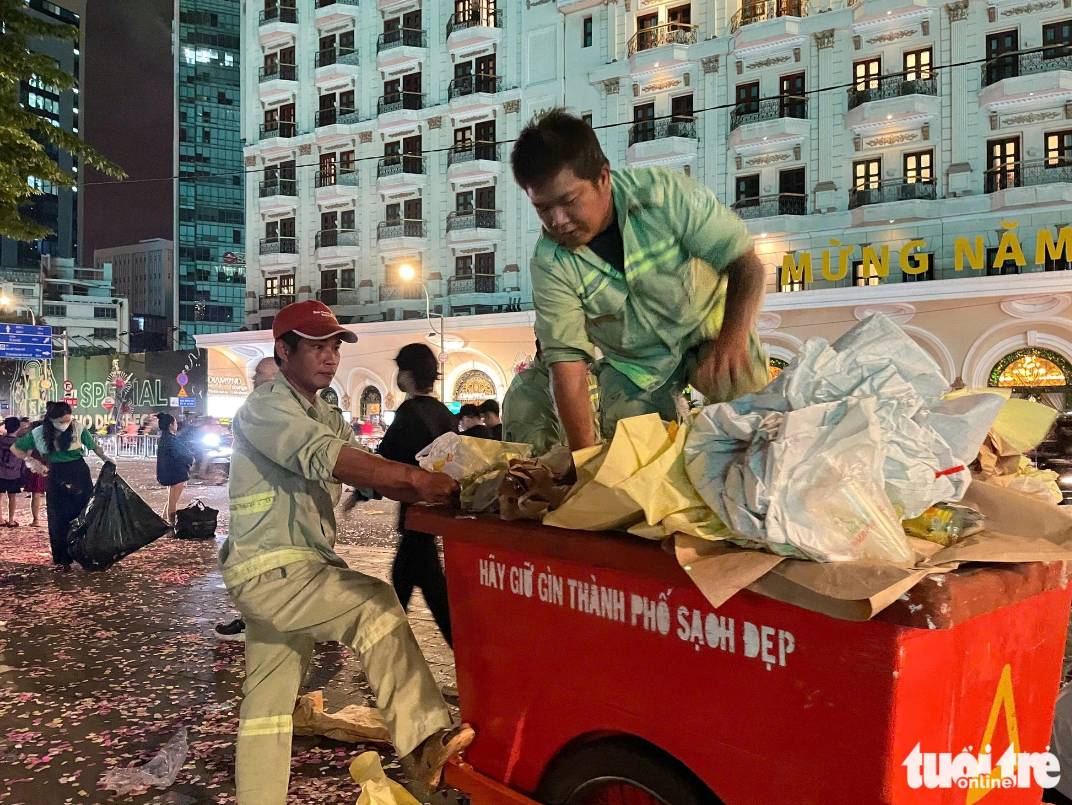 Sanitation workers clear up rubbish at Bach Dang Wharf in District 1, Ho Chi Minh City. Photo: Nguyen Khang / Tuoi Tre