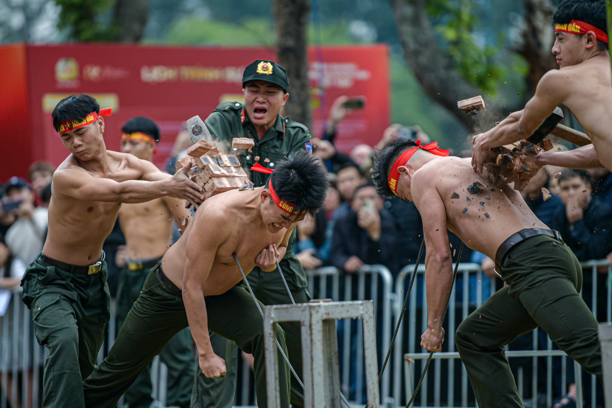 Two public security officers showcase a powerful qigong demonstration during a rehearsal in Hanoi, Vietnam, March 7, 2025. Photo: Nam Tran / Tuoi Tre