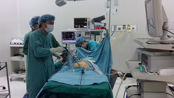 Êkíp lấy đầu đạn cho bệnh nhân - Ảnh: T.Lũy