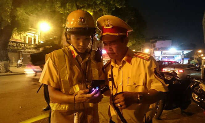 Lực lượng 141 xem lại hình ảnh người vi phạm trong camera hành trình để kiểm tra, xử lý vi phạm trong ngày đầu thí điểm sử dụng - Ảnh: M. L.