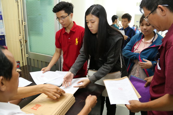 Thí sinh mua hồ sơ nhập học sau khi nhận giấy báo trúng tuyển tại Trường ĐH Sư phạm TP.HCM - Ảnh: NHƯ HÙNG
