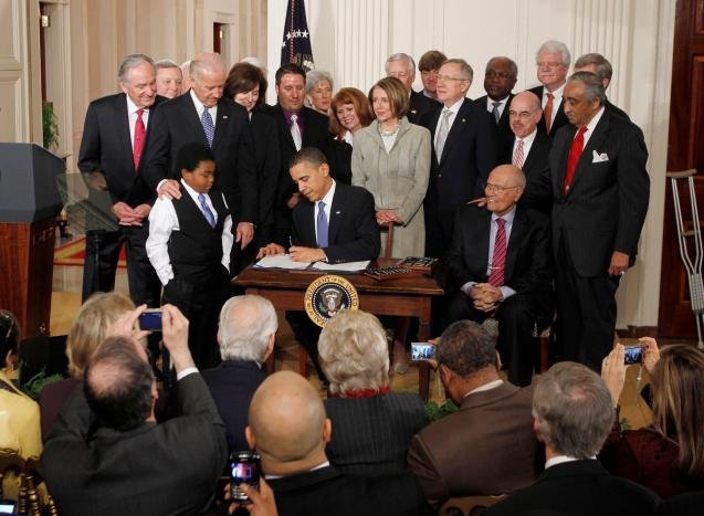 U.S. President Barack Obama waves to the audience after signing the Affordable Care Act, dubbed Obamacare, the comprehensive healthcare reform legislation during a ceremony in the East Room of the White House in Washington, U.S., March 23, 2010. REUTERS/Jason Reed/File Photo