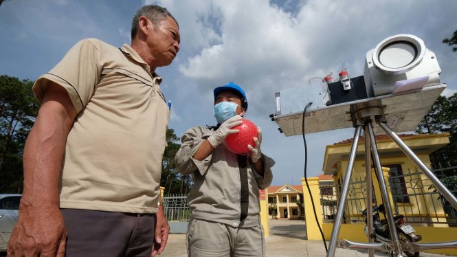 Người dân cùng kỹ thuật viên của Tổng cục môi trường quan trắc không khí khu vực hồ bùn đỏ trước nhà máy Alumin -
 Ảnh: Mai VInh