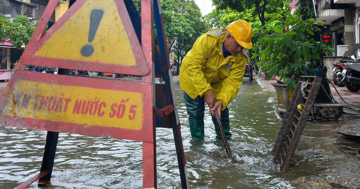 Công nhân thoát nước Hà Nội dầm mưa làm việc giữa đêm