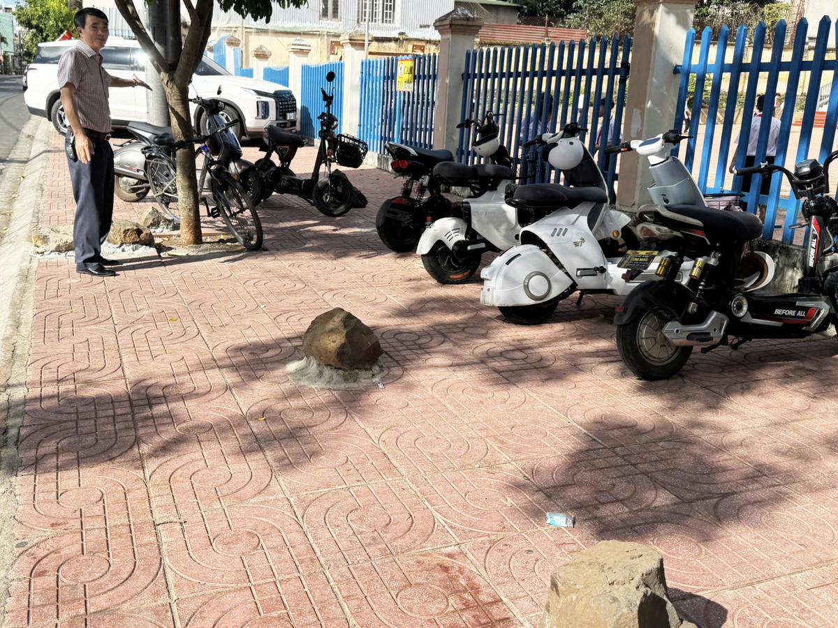 A rocky solution: giant boulders cemented outside Vietnam school to block sidewalk parking