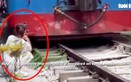 Train knocks phone away from woman at Hanoi's train street