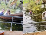 Đám bạn cười như được mùa khi hai cô gái chèo thuyền chìm xuống hồ nước