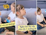 Chị gái nhăn mặt khi dụ dỗ em xin miếng bánh bất thành