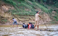 Students brave dangerous bamboo raft rides to school in Vietnam as authorities seek funds for safer crossing