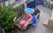 Cả nhà lấy chăn, thảm trùm ô tô để chống bão Wipha
