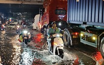 Triều cường dâng, người đi xe máy dò đường tránh ổ gà ở TP.HCM