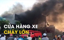 Người dân giúp chuyển xe máy ra khỏi cửa hàng xe cháy lớn