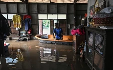 Thais navigate flooded homes and ancient temples by boat