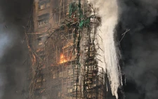 At least 13 dead after fire engulfs residential high-rise buildings in Hong Kong