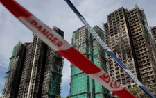 Hong Kong mourns victims of blaze that killed 128 and counting