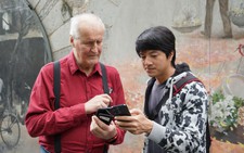 Through street photography workshops, visitors explore Hanoi one frame at a time