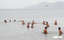 In Vietnam, tourists swim at beach ahead of storm Wipha despite ban