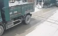 Đoàn xe ben nối đuôi qua đường sắt, một xe bất chấp dừng giữa đường ray