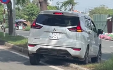 In Ho Chi Minh City, car driver crosses concrete median to avoid traffic