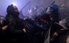 Police fire water cannon at protesters hurling smoke bombs in Olympic host Milan
