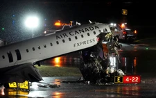 Passenger jet collides with fire truck in New York's LaGuardia, killing both pilots