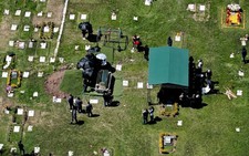 Flowers, music, and soldiers at funeral of drug lord
