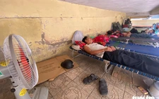 Families of patients shelter under hospital stairs as heat hits 40°C in central Vietnam