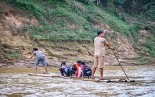 Students brave dangerous bamboo raft rides to school in Vietnam as authorities seek funds for safer crossing